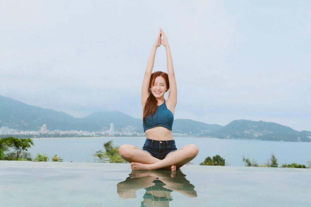 woman doing yoga on poolside